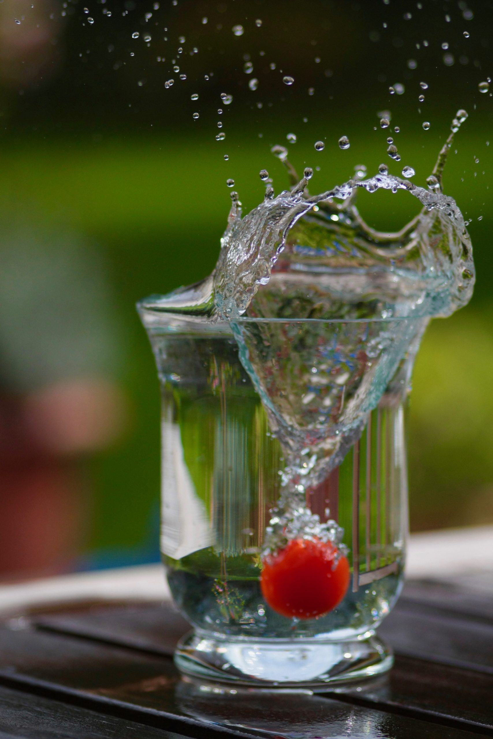 close-up-water-splashing-glass-table